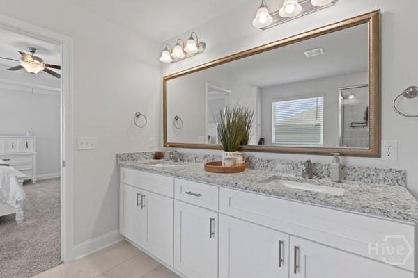 150 Pitch Point Trl, Richmond Hill, GA 31324 - ensuite bathroom featuring double vanity, ceiling fan, baseboards, and tile patterned flooring