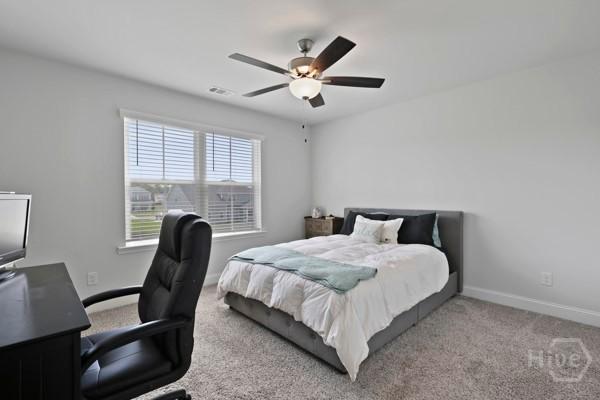 150 Pitch Point Trl, Richmond Hill, GA 31324 - bedroom featuring a desk, baseboards, carpet flooring, and a ceiling fan