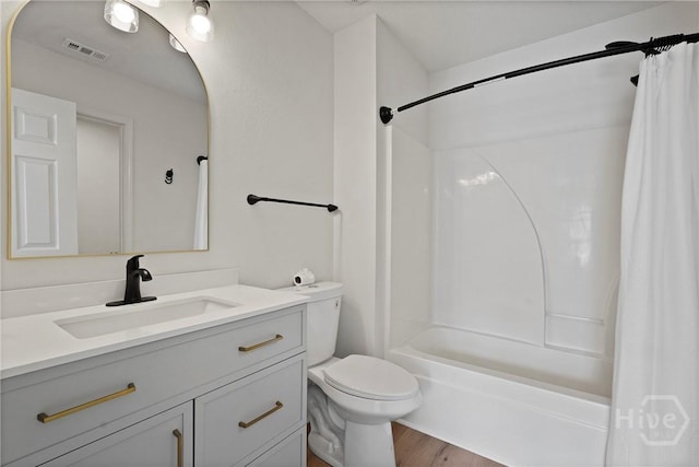 210 Walker Dr, Guyton, GA 31312 - full bathroom featuring vanity, shower / bath combo, toilet, and wood finished floors