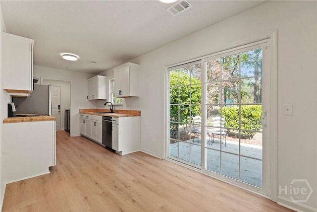 210 Walker Dr, Guyton, GA 31312 - kitchen with dishwasher, a sink, light wood-type flooring, white cabinetry, and baseboards
