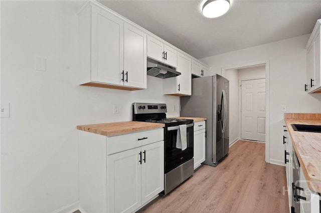 210 Walker Dr, Guyton, GA 31312 - kitchen featuring stainless steel appliances, under cabinet range hood, butcher block counters, white cabinetry, and light wood finished floors