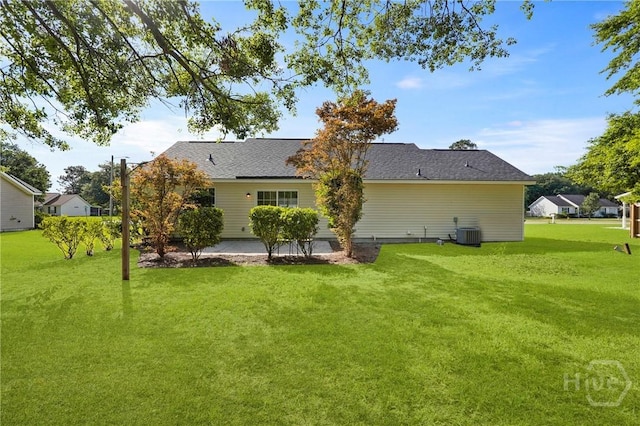 210 Walker Dr, Guyton, GA 31312 - back of property featuring central air condition unit and a lawn