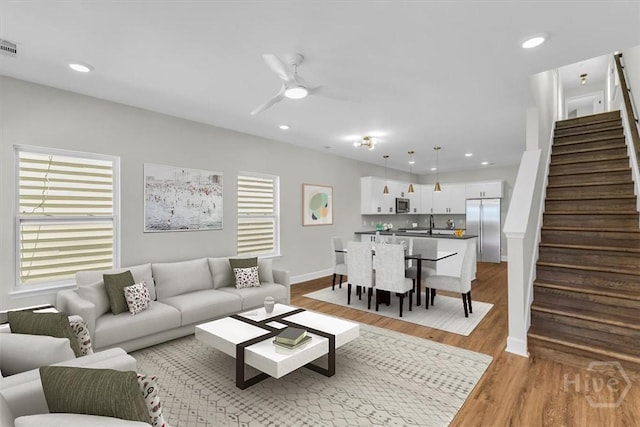 716 Waters Ave, Savannah, GA 31404 - living area featuring stairway, light wood-style floors, a ceiling fan, recessed lighting, and baseboards