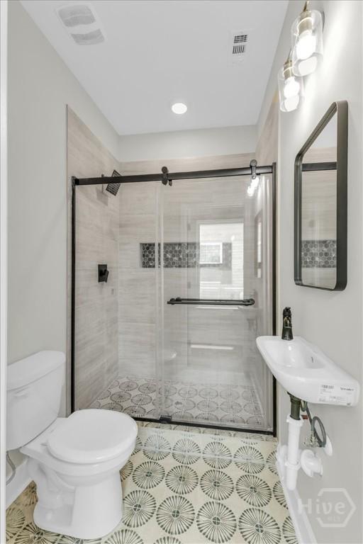 716 Waters Ave, Savannah, GA 31404 - bathroom with toilet, a shower stall, tile patterned flooring, and recessed lighting