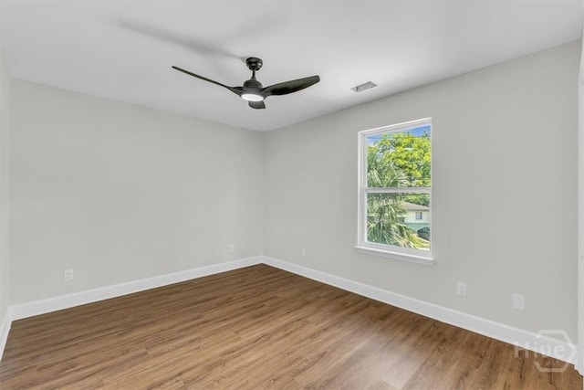 716 Waters Ave, Savannah, GA 31404 - unfurnished room with baseboards, wood finished floors, and ceiling fan