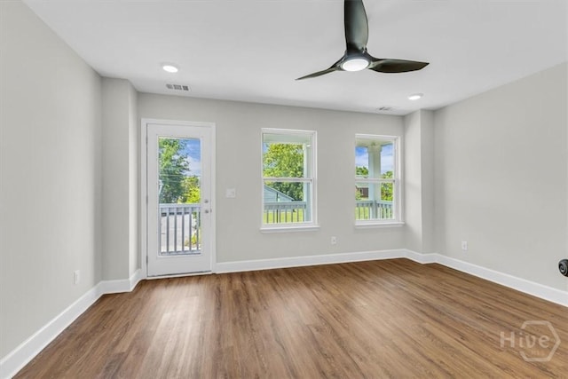 716 Waters Ave, Savannah, GA 31404 - unfurnished room with baseboards, wood finished floors, and a ceiling fan