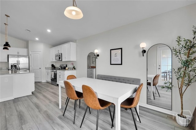 22 Stetson Dr, Savannah, GA 31419 - dining area with light wood-style flooring, arched walkways, recessed lighting, and lofted ceiling