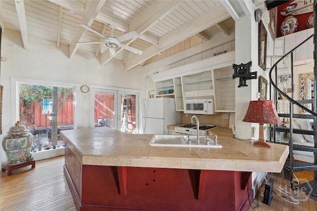 529 E Gordon St, Savannah, GA 31401 - kitchen featuring white appliances, a peninsula, light wood-style flooring, a ceiling fan, and a sink