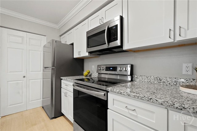 12300 Apache Ave Unit 1719, Savannah, GA 31419 - kitchen featuring appliances with stainless steel finishes, ornamental molding, white cabinetry, light wood-type flooring, and light stone counters