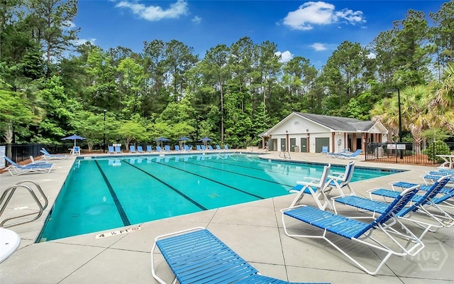 103 Safari Trl, Pooler, GA 31322 - community pool featuring a patio area and view of scattered trees