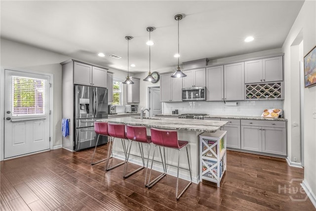 103 Safari Trl, Pooler, GA 31322 - kitchen featuring stainless steel appliances, gray cabinetry, a sink, light stone countertops, and decorative backsplash