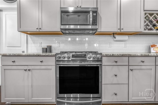 103 Safari Trl, Pooler, GA 31322 - kitchen featuring appliances with stainless steel finishes, backsplash, and light stone countertops