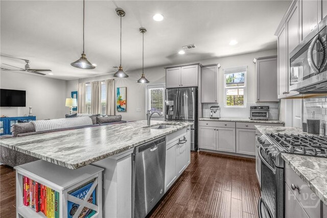 103 Safari Trl, Pooler, GA 31322 - kitchen featuring stainless steel appliances, a sink, open floor plan, backsplash, and dark wood-type flooring