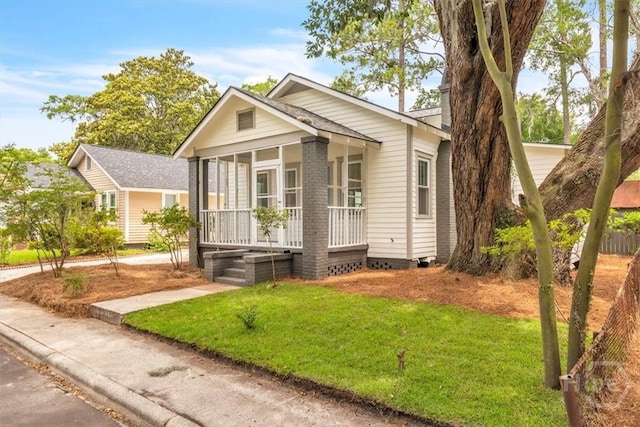 2136 Indiana Ave, Savannah, GA 31404 - view of front of house with a front yard and a sunroom