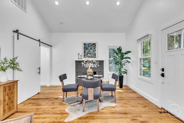 2136 Indiana Ave, Savannah, GA 31404 - dining area with lofted ceiling, a barn door, recessed lighting, light wood finished floors, and baseboards