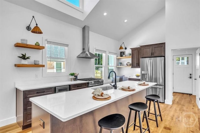 2136 Indiana Ave, Savannah, GA 31404 - kitchen with open shelves, stainless steel appliances, wall chimney exhaust hood, high vaulted ceiling, and a sink