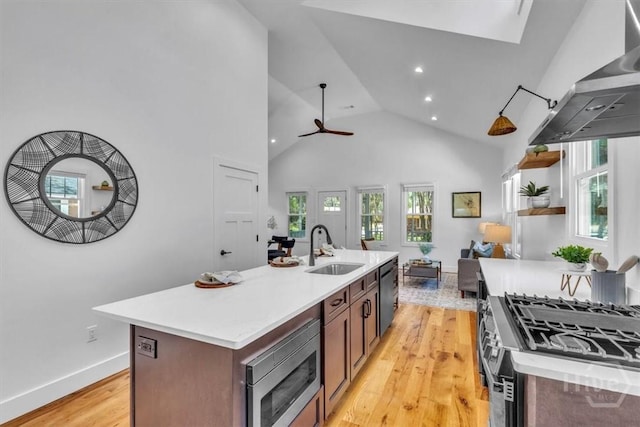 2136 Indiana Ave, Savannah, GA 31404 - kitchen with appliances with stainless steel finishes, a sink, wall chimney range hood, light wood finished floors, and light countertops