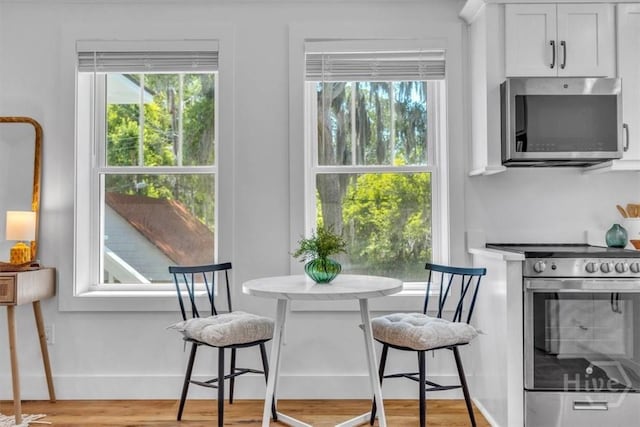 2136 Indiana Ave, Savannah, GA 31404 - dining area with light wood-style floors and baseboards