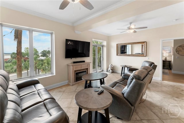 700 Wilmington Island Rd Unit 305, Savannah, GA 31410 - living room featuring a ceiling fan, baseboards, ornamental molding, a glass covered fireplace, and light tile patterned floors