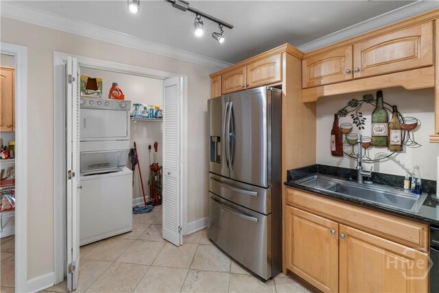 700 Wilmington Island Rd Unit 305, Savannah, GA 31410 - kitchen featuring stainless steel refrigerator with ice dispenser, stacked washer / dryer, dark countertops, ornamental molding, and light tile patterned floors