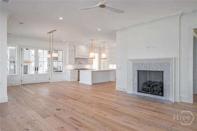 630 Ogeechee Ln, Richmond Hill, GA 31324 - unfurnished living room featuring ceiling fan, light wood-type flooring, recessed lighting, a fireplace, and a sink
