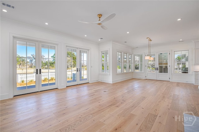 630 Ogeechee Ln, Richmond Hill, GA 31324 - unfurnished living room with french doors, plenty of natural light, light wood-type flooring, crown molding, and recessed lighting
