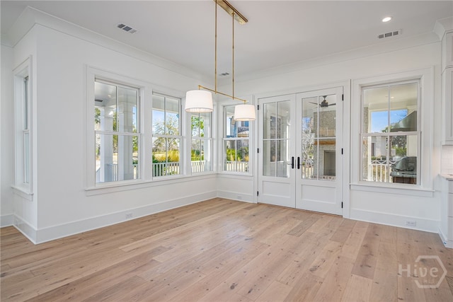 630 Ogeechee Ln, Richmond Hill, GA 31324 - unfurnished dining area with french doors, light wood finished floors, ornamental molding, and baseboards