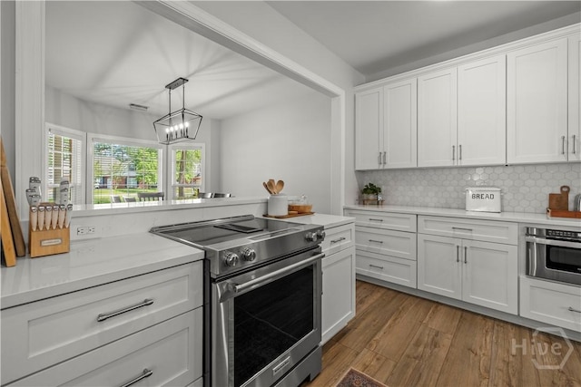 117 Myrtlewood Dr, Guyton, GA 31312 - kitchen with stainless steel appliances, white cabinetry, light countertops, and wood finished floors