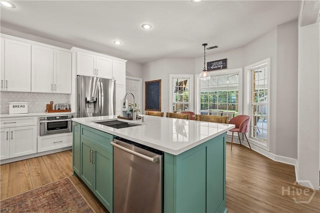 117 Myrtlewood Dr, Guyton, GA 31312 - kitchen featuring stainless steel appliances, green cabinetry, a sink, recessed lighting, and white cabinetry