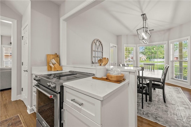 117 Myrtlewood Dr, Guyton, GA 31312 - kitchen featuring stainless steel range with electric stovetop, white cabinets, and wood finished floors