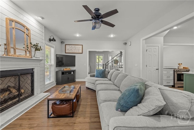 117 Myrtlewood Dr, Guyton, GA 31312 - living room featuring stairs, a ceiling fan, wood finished floors, a fireplace with raised hearth, and recessed lighting