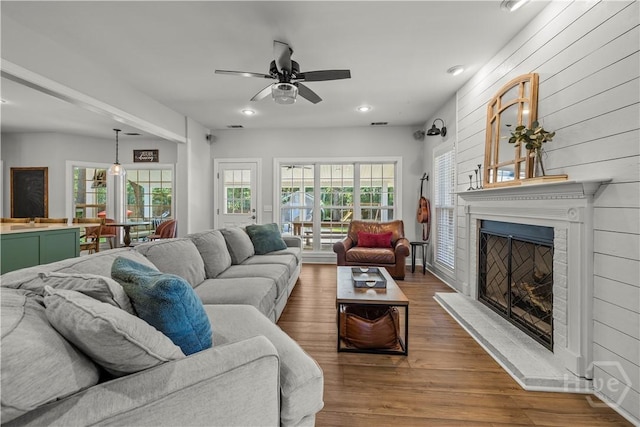 117 Myrtlewood Dr, Guyton, GA 31312 - living area featuring a fireplace with raised hearth, a ceiling fan, healthy amount of natural light, wood finished floors, and recessed lighting