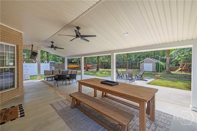 117 Myrtlewood Dr, Guyton, GA 31312 - view of patio / terrace featuring an outdoor living space with a fire pit, a playground, outdoor dining space, and ceiling fan