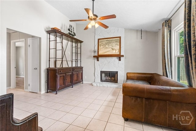 103 Mapmaker Cv, Savannah, GA 31410 - living room featuring ceiling fan, light tile patterned floors, a stone fireplace, vaulted ceiling, and baseboards