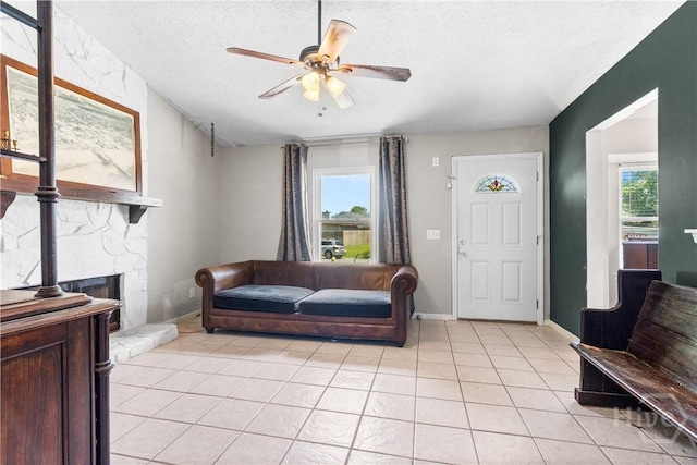 103 Mapmaker Cv, Savannah, GA 31410 - living area featuring healthy amount of natural light, a ceiling fan, light tile patterned floors, and a textured ceiling
