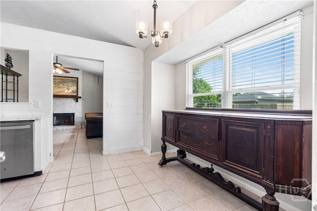 103 Mapmaker Cv, Savannah, GA 31410 - dining area with a large fireplace, ceiling fan, light tile patterned floors, baseboards, and a chandelier