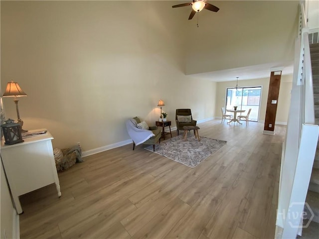 61 Port Dr, Richmond Hill, GA 31324 - sitting room with a ceiling fan, wood finished floors, baseboards, a chandelier, and stairway