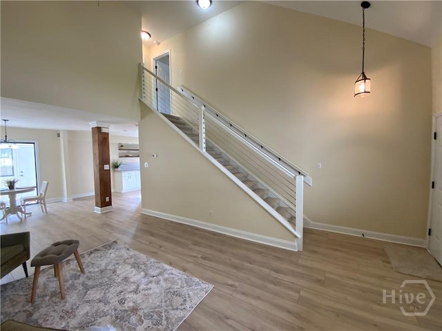 61 Port Dr, Richmond Hill, GA 31324 - stairs featuring high vaulted ceiling, wood finished floors, and baseboards