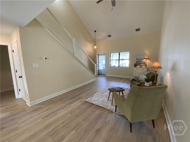 61 Port Dr, Richmond Hill, GA 31324 - living area featuring wood finished floors, ceiling fan, baseboards, stairs, and high vaulted ceiling