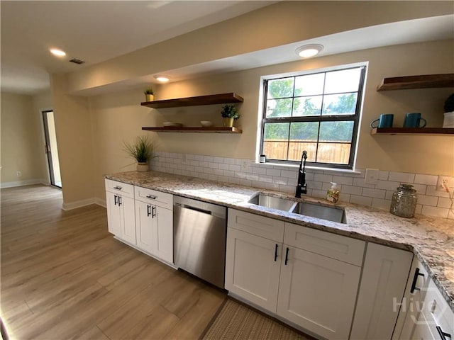 61 Port Dr, Richmond Hill, GA 31324 - kitchen featuring dishwasher, a sink, open shelves, light wood finished floors, and tasteful backsplash