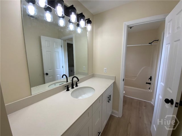 61 Port Dr, Richmond Hill, GA 31324 - bathroom with vanity, wood finished floors,  shower combination, toilet, and baseboards