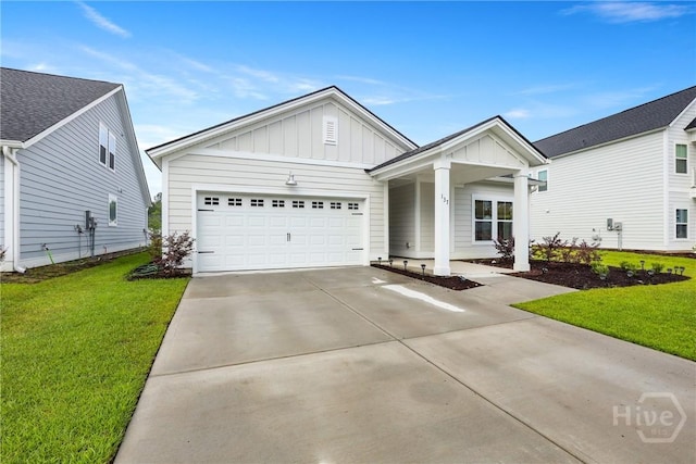 137 Binscombe Ln, Pooler, GA 31322 - view of front of house with board and batten siding, a garage, driveway, and a front yard