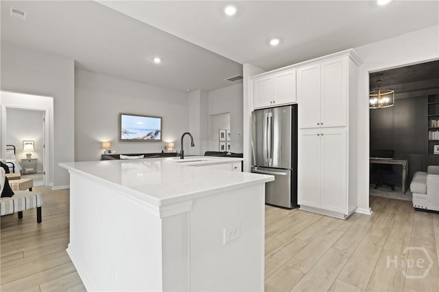 137 Binscombe Ln, Pooler, GA 31322 - kitchen featuring freestanding refrigerator, a sink, white cabinets, light wood-style floors, and light countertops
