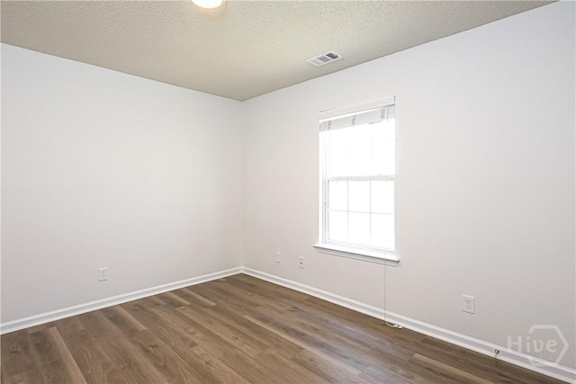 42 Tiller Way, Port Wentworth, GA 31407 - unfurnished room with dark wood-style flooring and a textured ceiling