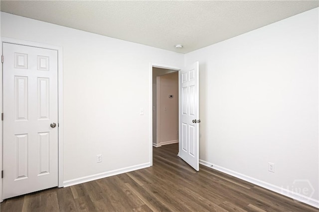 42 Tiller Way, Port Wentworth, GA 31407 - unfurnished room with dark wood-style floors, a smoke detector, and a textured ceiling