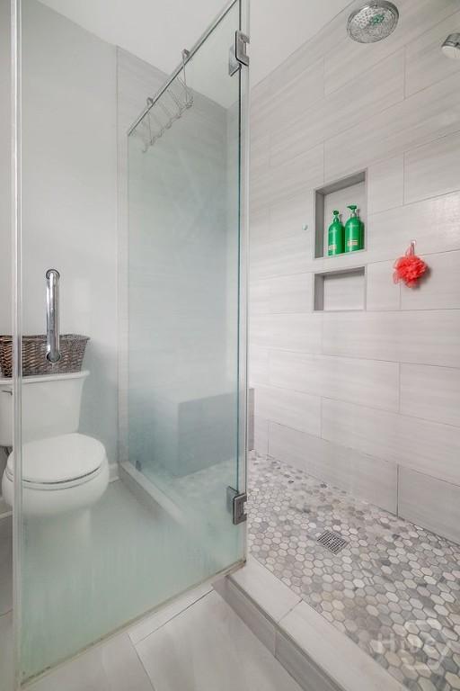 101 Sabal Ln, Savannah, GA 31405 - bathroom with toilet, a shower stall, and tile patterned flooring