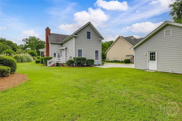 101 Sabal Ln, Savannah, GA 31405 - rear view of house featuring a chimney and a yard