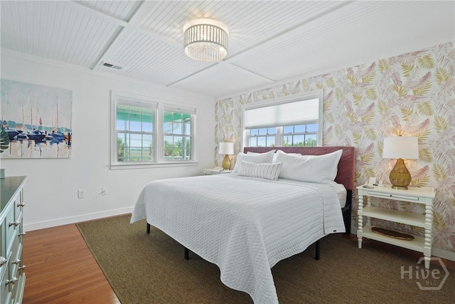 132 Pelican Dr, Tybee Island, GA 31328 - bedroom featuring baseboards, wood finished floors, a chandelier, and coffered ceiling