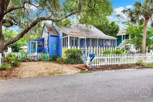 14 Bright St, Tybee Island, GA 31328 - bungalow featuring a sunroom and roof with shingles