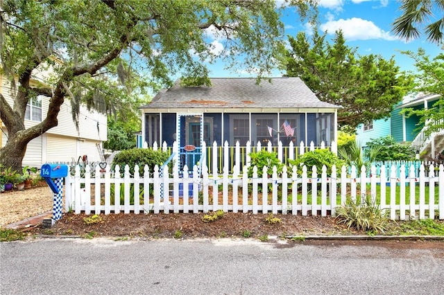 14 Bright St, Tybee Island, GA 31328 - bungalow featuring a sunroom and roof with shingles